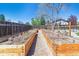 A fenced backyard with raised garden beds at 3195 S Kalispell Ct, Aurora, CO 80013