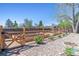Backyard with a wooden fence and raised garden beds surrounded by pea gravel at 3195 S Kalispell Ct, Aurora, CO 80013