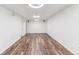 Large, white basement with recessed lighting and wood-look vinyl flooring at 3195 S Kalispell Ct, Aurora, CO 80013