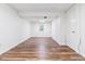 Spacious basement area with modern wood-look flooring, white walls, and a window at 3195 S Kalispell Ct, Aurora, CO 80013