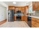Modern kitchen with stainless steel appliances, custom cabinets and light wood-look flooring at 3195 S Kalispell Ct, Aurora, CO 80013