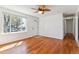Bright living room featuring gleaming hardwood floors, large windows, and fresh paint at 3195 S Kalispell Ct, Aurora, CO 80013