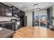 Stylish kitchen with dark cabinets, stainless steel appliances, hardwood floors, and sliding doors to the backyard at 19603 E 63Rd Pl, Aurora, CO 80019