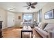 Bright living room with hardwood floors, neutral walls, a ceiling fan, and a large window with a view at 19603 E 63Rd Pl, Aurora, CO 80019