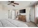 Serene bedroom featuring neutral colors, carpeted floors, a dresser, and access to an ensuite bathroom and closet at 19603 E 63Rd Pl, Aurora, CO 80019