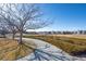 View of a neighborhood park with a walking path and grassy area at 19603 E 63Rd Pl, Aurora, CO 80019