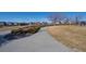 Wide walking path in a community park with landscaped bushes, grass, and neighborhood homes at 19603 E 63Rd Pl, Aurora, CO 80019