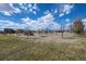 Community playground with slides and swings under a sunny blue sky. Houses in the background at 19603 E 63Rd Pl, Aurora, CO 80019