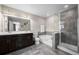 Bathroom boasts double vanity, bathtub, and a separate glass shower, for a relaxing experience at 21833 E Quincy Pl, Aurora, CO 80015