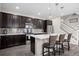 Kitchen with a counter, dark cabinets, and stainless steel appliances at 21833 E Quincy Pl, Aurora, CO 80015