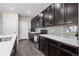 Kitchen with a counter, dark cabinets, and stainless steel appliances at 21833 E Quincy Pl, Aurora, CO 80015