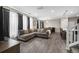 Living room with gray modern sofa and hardwood flooring leading to the kitchen at 21833 E Quincy Pl, Aurora, CO 80015