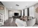 Living room with gray modern sofa and hardwood flooring at 21833 E Quincy Pl, Aurora, CO 80015