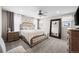 Bright main bedroom with ceiling fan, large window, and decorative headboard at 21833 E Quincy Pl, Aurora, CO 80015