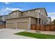 Two-story home with a two-car garage and a well-maintained front yard under a blue sky at 21833 E Quincy Pl, Aurora, CO 80015