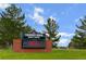 Thunder Ridge Middle School signage set on a brick base, surrounded by green grass and trees at 21833 E Quincy Pl, Aurora, CO 80015