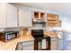 Functional kitchen with sleek black appliances, wood countertops, and ample storage space at 4246 S Eldridge St # 103, Morrison, CO 80465