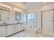 Elegant bathroom featuring a soaking tub, double vanity, and walk-in shower at 6938 S Riverwood Way, Aurora, CO 80016