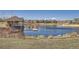 Scenic community lake with gazebo and dock, offering a peaceful waterfront view at 6938 S Riverwood Way, Aurora, CO 80016