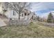 House exterior showcasing landscaping, retaining wall, and backyard at 6938 S Riverwood Way, Aurora, CO 80016