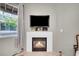 Modern fireplace with white mantel and mounted TV at 1049 S Walden Way # 155, Aurora, CO 80017