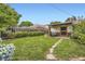 Lush backyard showcasing a sprawling green lawn and a charming covered patio at 1292 Kearney St, Denver, CO 80220