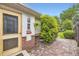 Charming backyard exterior with brickwork and a tidy garden, next to a wooden door at 1292 Kearney St, Denver, CO 80220