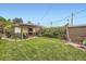 Landscaped backyard featuring a well-maintained lawn and cozy covered patio area at 1292 Kearney St, Denver, CO 80220