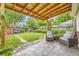 Landscaped backyard with a pergola covered patio, lush lawn, and comfortable seating at 1292 Kearney St, Denver, CO 80220