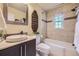 Well-lit bathroom with tiled shower and tub, elegant fixtures, and modern vanity at 1292 Kearney St, Denver, CO 80220