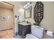 Modern half-bathroom featuring elegant fixtures, unique décor, and ample lighting at 1292 Kearney St, Denver, CO 80220