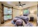 Inviting bedroom with an exterior view, a ceiling fan, soft lighting, and comfortable furnishings at 1292 Kearney St, Denver, CO 80220