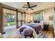 Bright bedroom with backyard access, barn doors, hardwood floors, ceiling fan, and ample natural light at 1292 Kearney St, Denver, CO 80220