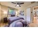 Comfortable bedroom with a ceiling fan, hardwood floors, soft lighting, and modern decor at 1292 Kearney St, Denver, CO 80220