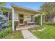 Inviting front porch with seating, decorative lights, and a well-maintained garden and brickwork at 1292 Kearney St, Denver, CO 80220