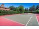 Outdoor tennis court surrounded by lush greenery, perfect for recreational play at 1292 Kearney St, Denver, CO 80220