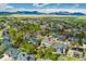 Expansive aerial view showcasing a suburban neighborhood with mountain views, lush greenery, and residential properties at 2822 Flint Ct, Superior, CO 80027