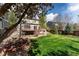 Spacious backyard featuring a well-maintained lawn, deck with stairs, and mature trees at 2822 Flint Ct, Superior, CO 80027