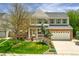 Charming two-story home featuring a brick facade, well-manicured lawn, and an attached two-car garage at 2822 Flint Ct, Superior, CO 80027