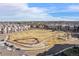 Aerial view of community with open green space and surrounding townhomes at 400 E Fremont Pl # 205, Littleton, CO 80122