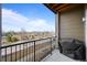 View from the balcony showing the neighborhood with railing, brown siding and a barbeque grill at 400 E Fremont Pl # 205, Littleton, CO 80122