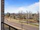 Balcony view featuring a street, trees, and distant mountain views at 400 E Fremont Pl # 205, Littleton, CO 80122