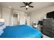 Cozy bedroom with ensuite bath featuring a ceiling fan and a workspace with a desk at 400 E Fremont Pl # 205, Littleton, CO 80122