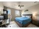 Comfortable bedroom with a large window, ceiling fan, desk, and a spacious closet at 400 E Fremont Pl # 205, Littleton, CO 80122