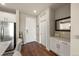Bright entryway with wood floors, coat hooks, and modern decor at 400 E Fremont Pl # 205, Littleton, CO 80122