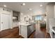 Well-lit kitchen with a modern island, stainless steel dishwasher, and wood flooring at 400 E Fremont Pl # 205, Littleton, CO 80122