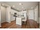 Bright kitchen featuring a kitchen island, stainless steel appliances, and wood flooring at 400 E Fremont Pl # 205, Littleton, CO 80122