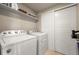 Bright laundry room features a full-size washer and dryer and ample storage at 400 E Fremont Pl # 205, Littleton, CO 80122