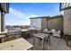 Community outdoor kitchen with a gas grill, tables, seating, and a fire pit at 400 E Fremont Pl # 205, Littleton, CO 80122