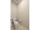 Powder room with updated toilet, toilet paper holder and tile floors at 400 E Fremont Pl # 205, Littleton, CO 80122